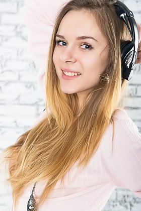Brown-haired beauty posing with her headphones on and her tits out Videos